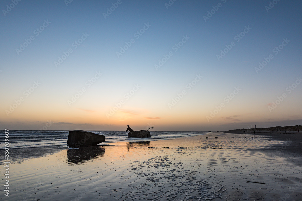 danish beach at sunset with ww2 bunkers danish beach at sunset with ww2 bunkers