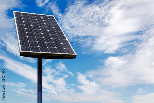 Small solar panel against a cloud filled blue sky