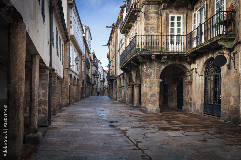 Pedestrian street and historic building facades in old town Santiago de Compostela, Spain.