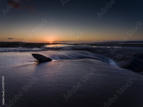 Sunset at low tide on the Loughor Estuary, Penclawdd, North Gower, Swansea, UK