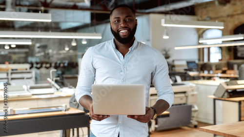 A client is First. Confident male worker posing in office photo