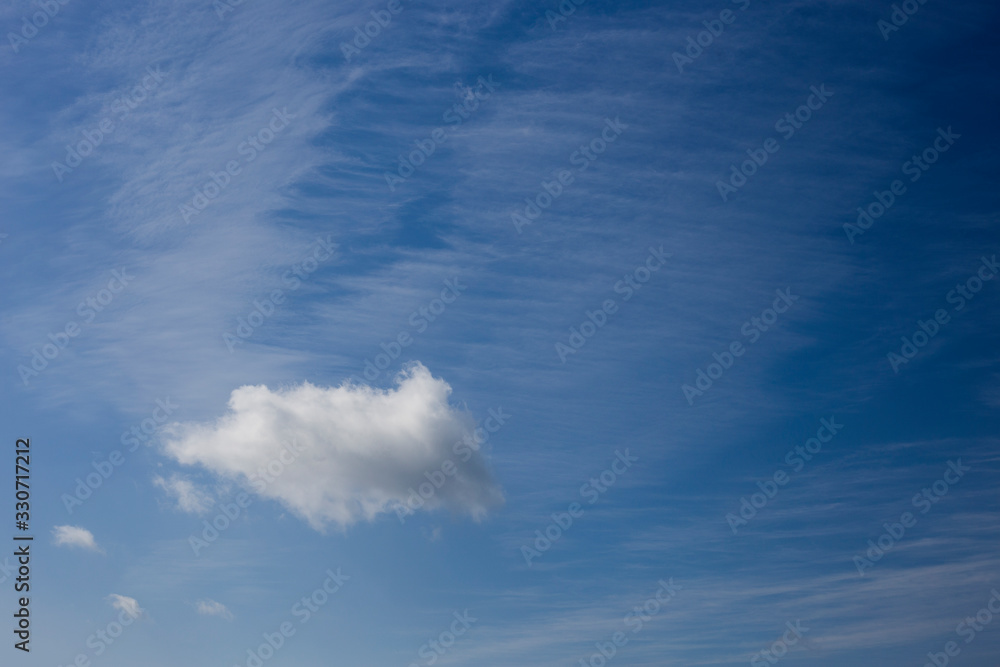 isolated cumulonimbus cloud and cirrus on a blue sky background isolated cumulonimbus cloud and cirrus on a blue sky background