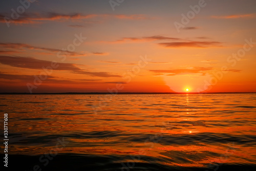 Beautiful colorful sunset on the sea coast. Nice scene with sunrise over water