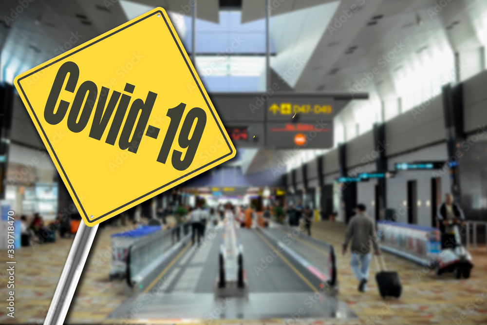 Passenger at airport with Covid-19 Sign Passenger at airport with Covid-19 Sign