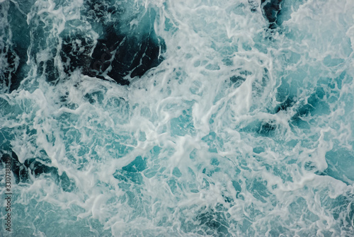 Sea ​​waves turquoise with dark blue tones and white foam, background © Tatiana Dragunova