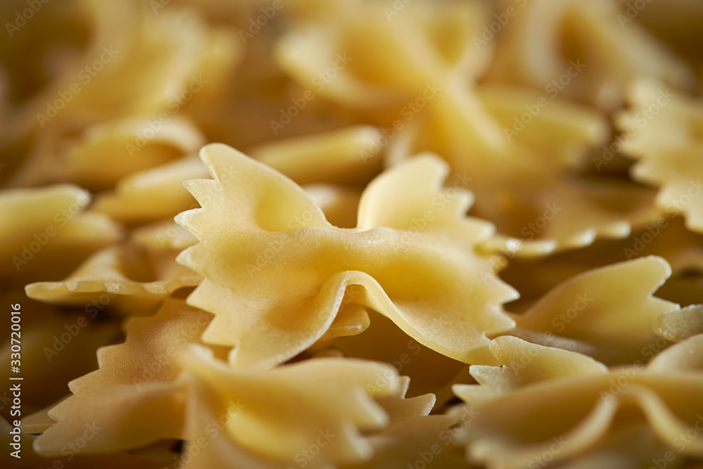 Dried farfalle short pasta background Dried farfalle short pasta background