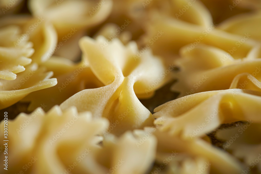 Dried farfalle short pasta background 