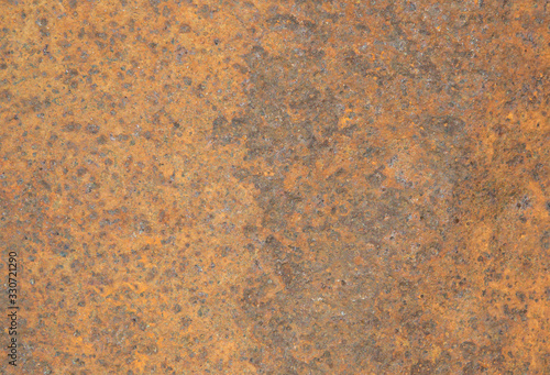 The texture of a sheet of heavily rusty iron with deep potholes and caverns. The vintage background is not single-handed, with brown spots of corrosion. © Sergei