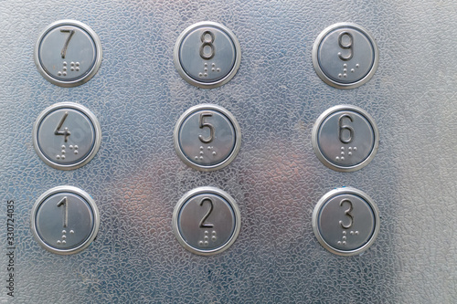 Elevator buttons with Braille close-up