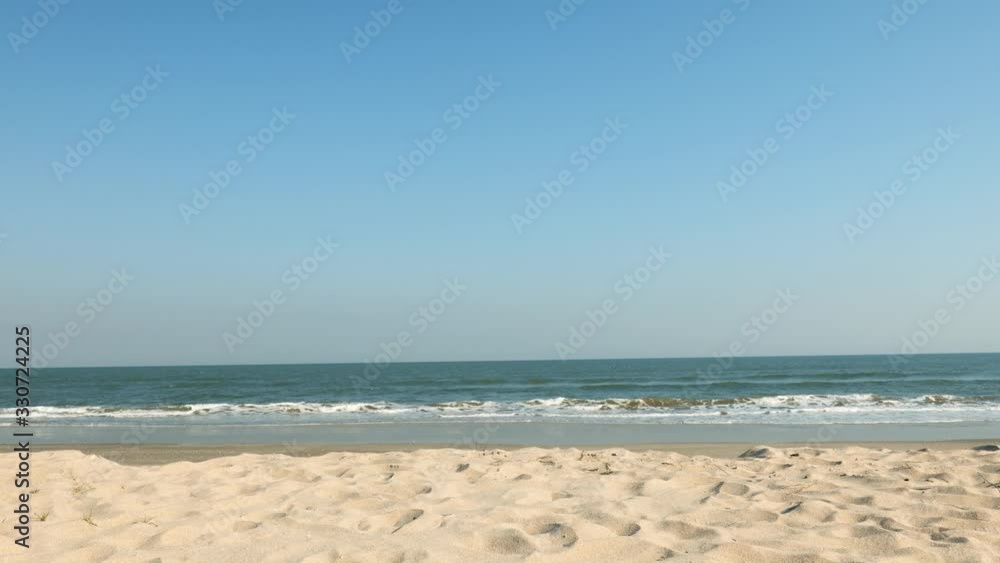 A man reachs the beach and makes a victory sign A man reachs the beach and makes a victory sign