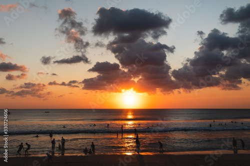Fototapeta Naklejka Na Ścianę i Meble -  Beautiful sunset and silhouette of different people on the beach