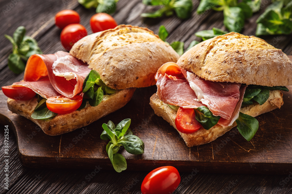 Jamon sandwiches with tomatoes, on wooden board. - obrazy, fototapety, plakaty 