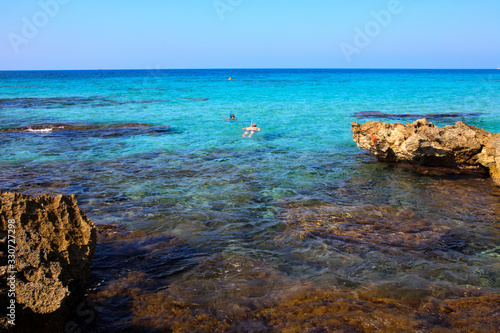 Son Bou, Menorca / Spain - June 22, 2016: Rocks at Son Bou beach near Alaior, Menorca, Balearic Islands, Spain photo