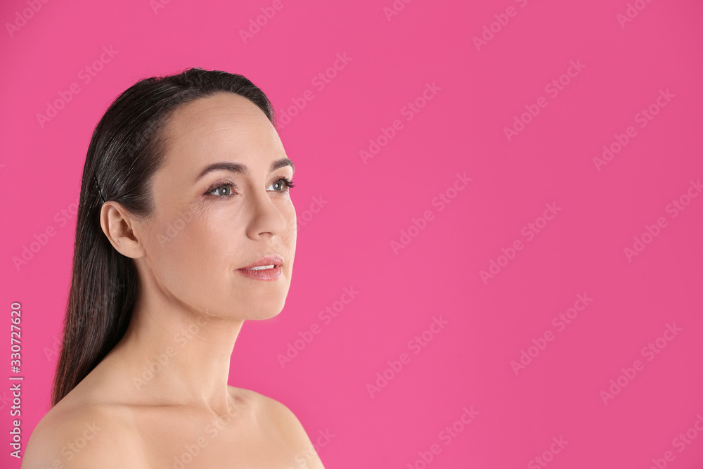 Portrait of beautiful mature woman on pink background. Space for text Portrait of beautiful mature woman on pink background. Space for text