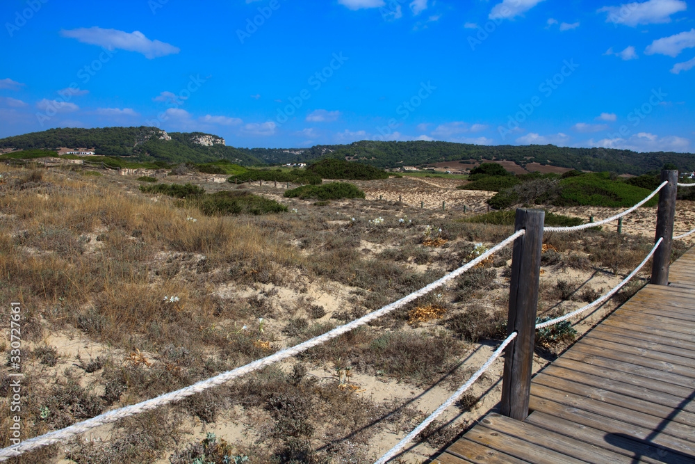 Son Bou, Menorca / Spain - June 22, 2016: The dunes park area at Son Bou beach near Alaior, Menorca, Balearic Islands, Spain Son Bou, Menorca / Spain - June 22, 2016: The dunes park area at Son Bou beach near Alaior, Menorca, Balearic Islands, Spain