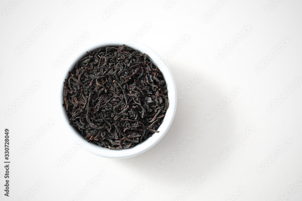 Earl gray tea, black tea flavored with bergamot oil. Black tea on white background, isolated top view. Earl gray tea, black tea flavored with bergamot oil. Black tea on white background, isolated top view.