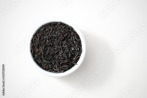 Earl gray tea, black tea flavored with bergamot oil. Black tea on white background, isolated top view.