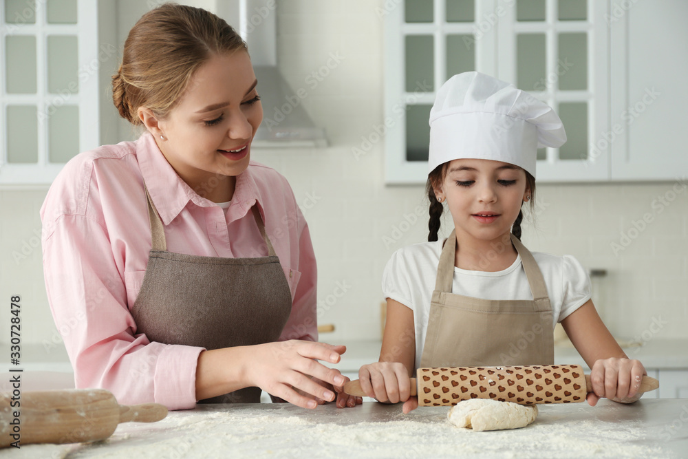 Mother and daughter cooking together in kitchen Mother and daughter cooking together in kitchen