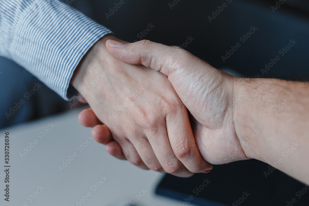 Fototapeta premium Closeup of woman and man business handshake. Hands together. Work agreement and colaboration, Successful negotiantion and cooperation. Business, freelance, job concept.