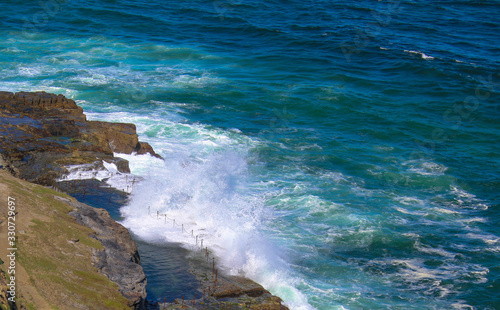 Newcastle rocks crashing blue wave