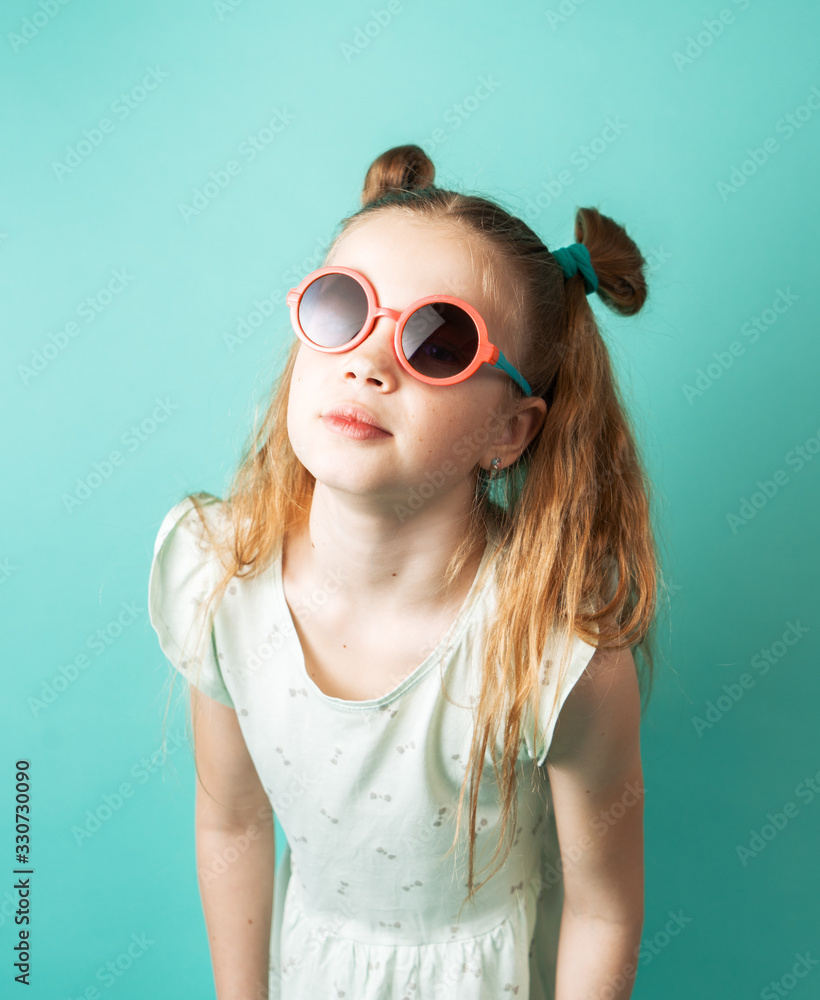 Bright colors: a girl in sunglasses on a green background. Bright colors: a girl in sunglasses on a green background.