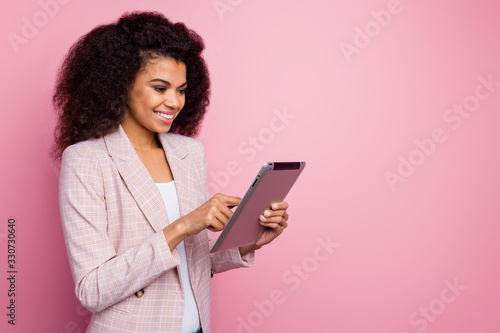 Profile photo of amazing pretty dark skin business lady hold e-book hands successful young professional searching information online wear plaid blazer isolated pastel pink color background