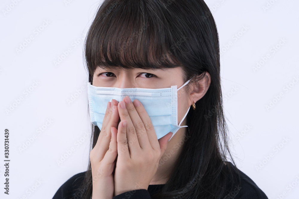 Woman coughing with face mask - young Asian covering the mouth by hand, feeling unwell illness isolated on white background, close up, copy space Woman coughing with face mask - young Asian covering the mouth by hand, feeling unwell illness isolated on white background, close up, copy space