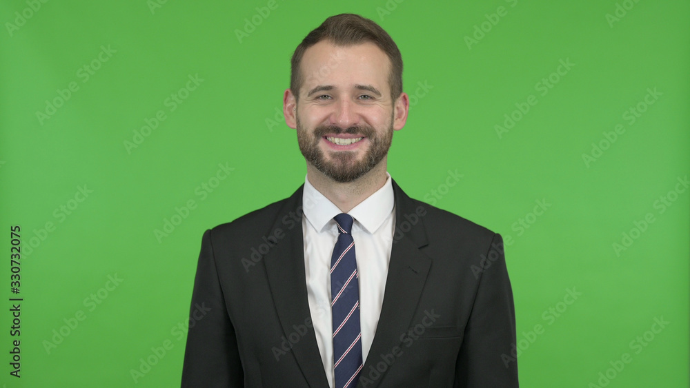 The Young Businessman Smiling against Chroma Key The Young Businessman Smiling against Chroma Key