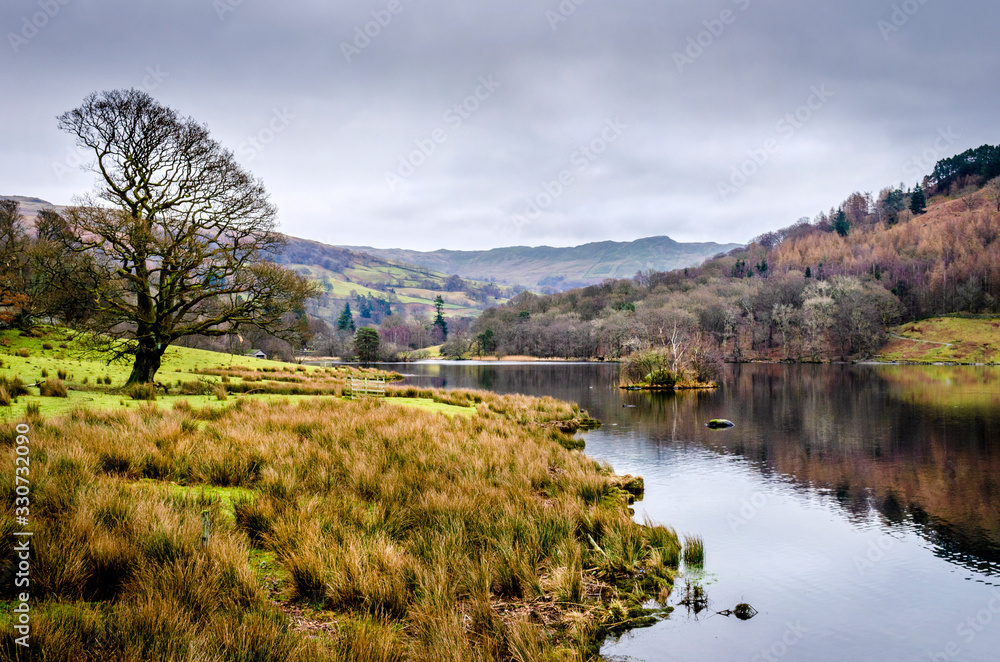 A calm winter view of Elterwater in the Great Langdale lake district Cumbria.
