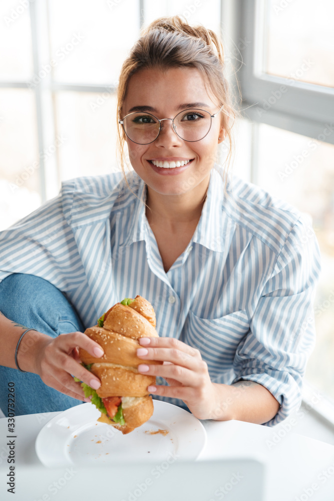 Smiling young businesswoman having lunch Smiling young businesswoman having lunch
