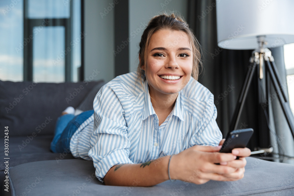 Happy young businesswoman using mobile phone Happy young businesswoman using mobile phone