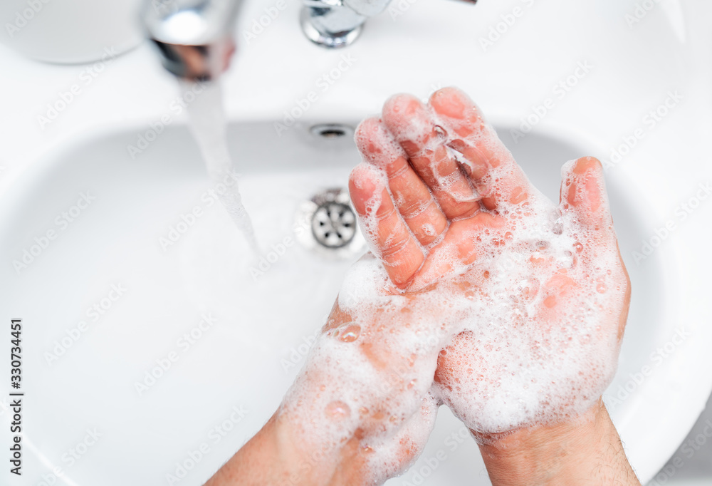 Fototapeta premium Personal hygiene, cleaning hands with soap often on faucet to protect from virus.