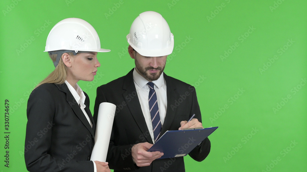The Happy Engineers Looking at Construction work Against Chroma Key The Happy Engineers Looking at Construction work Against Chroma Key