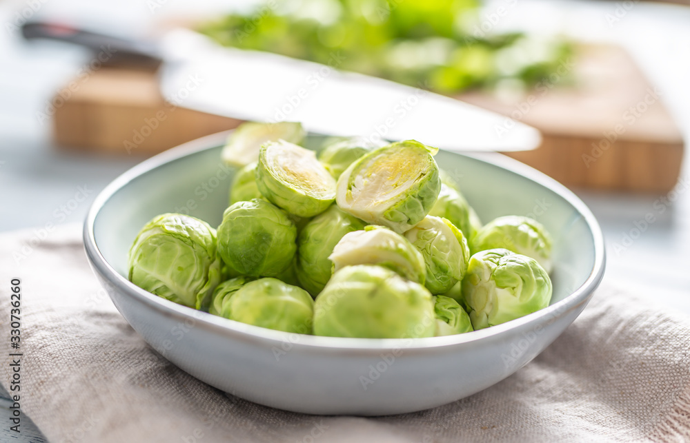 Fresh brusseles sprouts in bowl on kitchen table Fresh brusseles sprouts in bowl on kitchen table