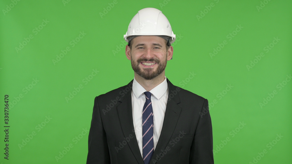 The Cheerful Engineer Smiling at Camera against Chroma Key The Cheerful Engineer Smiling at Camera against Chroma Key