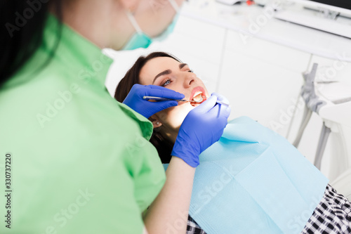 Dentist doing dental checkup for his patient
