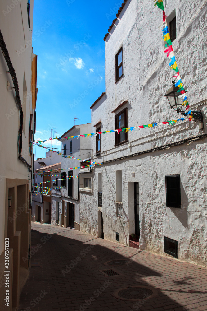 Alaior, Menorca / Spain - June 25, 2016: View of Alajor road and houses, Menorca, Balearic Islands, Spain