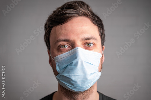 Coronavirus COVID-19 quarantine lockdown. Man in medical face mask. Protection against pandemic virus disease MERS-Cov, Novel Coronavirus. Virus outbreak in 2020. Stay at home campaign