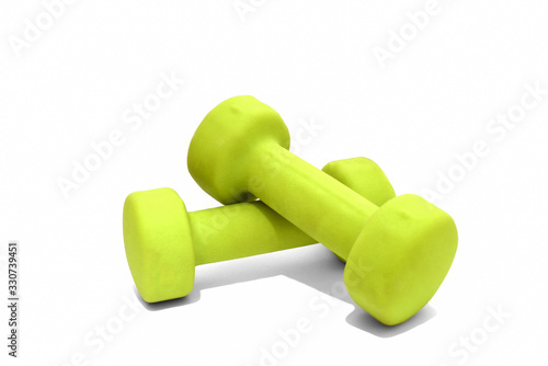 Two green dumbbells isolated on white background