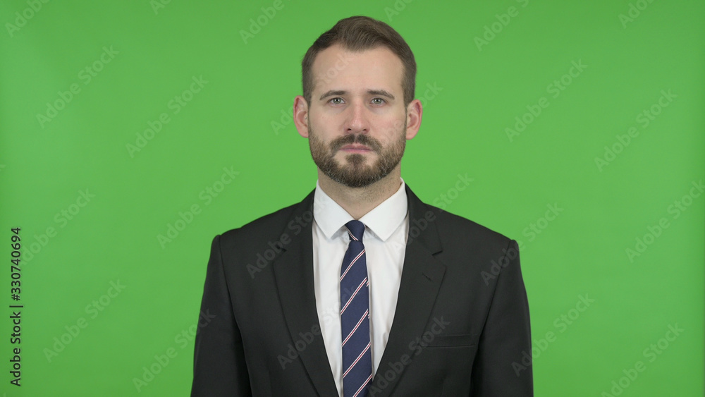 The Young Businessman looking in Camera against Chroma Key The Young Businessman looking in Camera against Chroma Key