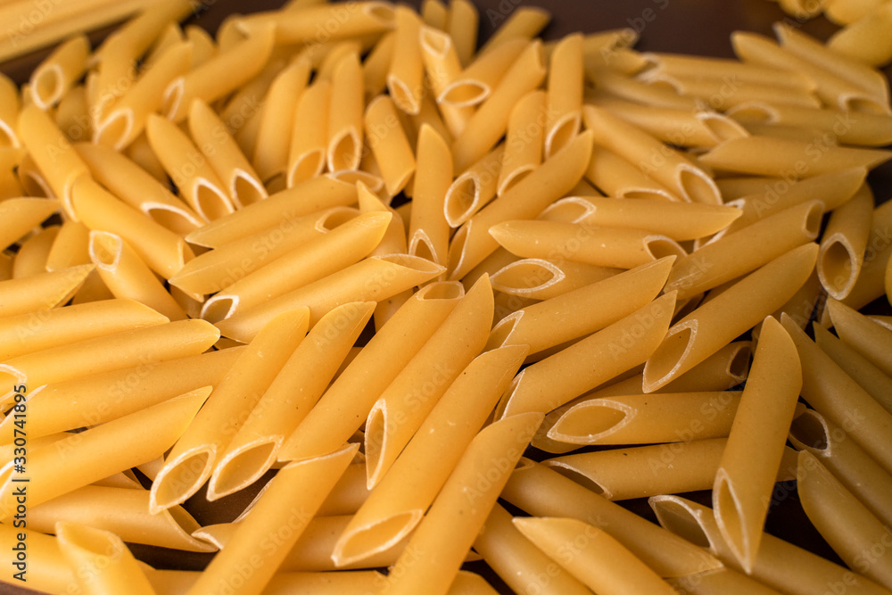 scattering Italian pasta penne, feathers scattering Italian pasta penne, feathers