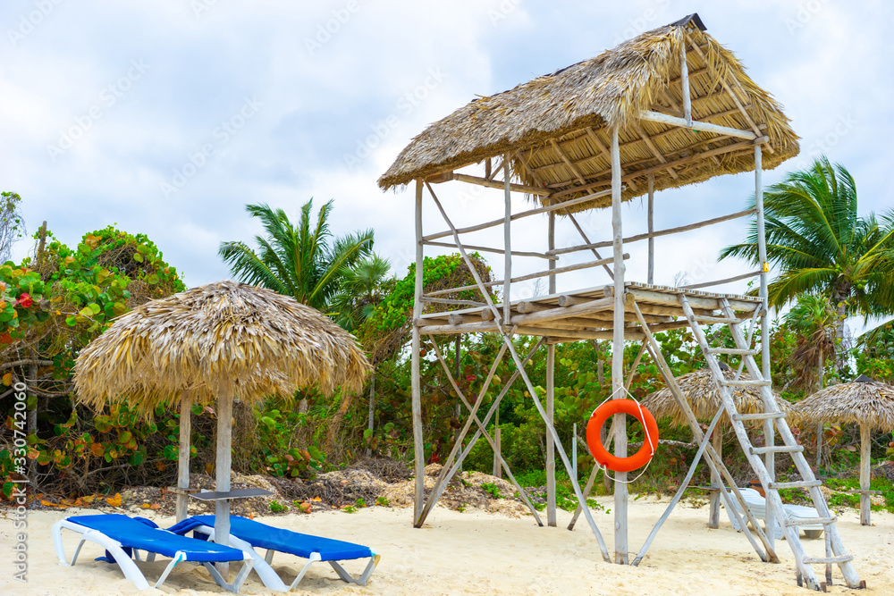 Republic of Cuba. Beach chairs and a lifeguard booth on the Caribbean coast. An empty beach in Cuba. Beach holiday. Vacation on the Caribbean coast. Vacation in Cuba.