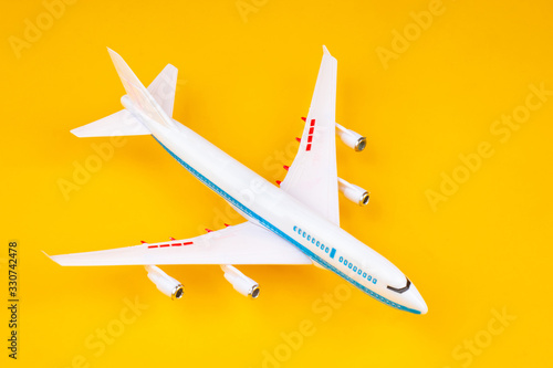 White plane on a yellow bac...