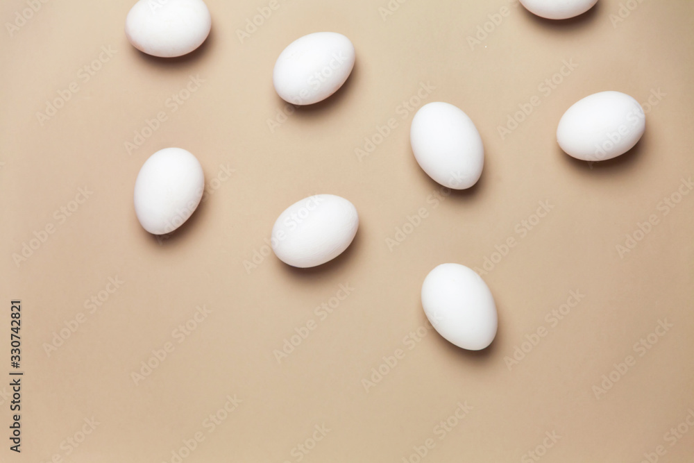 Creative Easter beige and pink background with white eggs. Easter holiday minimal concept.