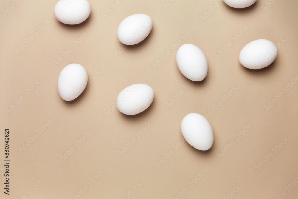 Creative Easter beige and pink background with white eggs. Easter holiday minimal concept. Creative Easter beige and pink background with white eggs. Easter holiday minimal concept.