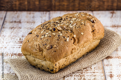 vegan bread with nuts and chestnuts, without sugar or gluten. Rustic wooden background, background image for bakeries and snack bars, space for text.