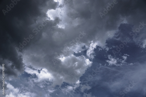 Terrible thunderclouds from the side of a plane. Gloomy epic clouds. Background image in a dark gray style.