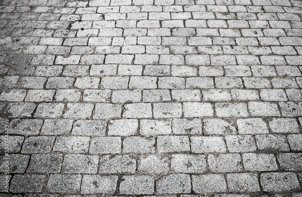 cobbled street with square blocks of gray granite stone. Background