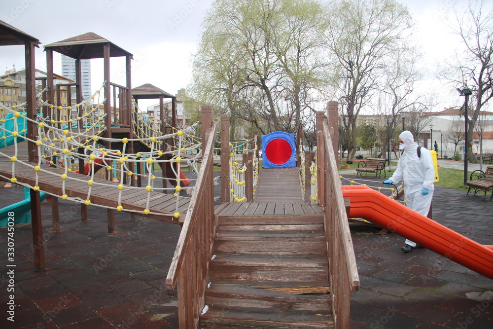 Ankara, Turkey - March 16, 2020: Workers sprays disinfectant as part of preventive measures against the spread of the COVID-19, the novel coronavirus, in a playgarden Ankara, Turkey - March 16, 2020: Workers sprays disinfectant as part of preventive measures against the spread of the COVID-19, the novel coronavirus, in a playgarden