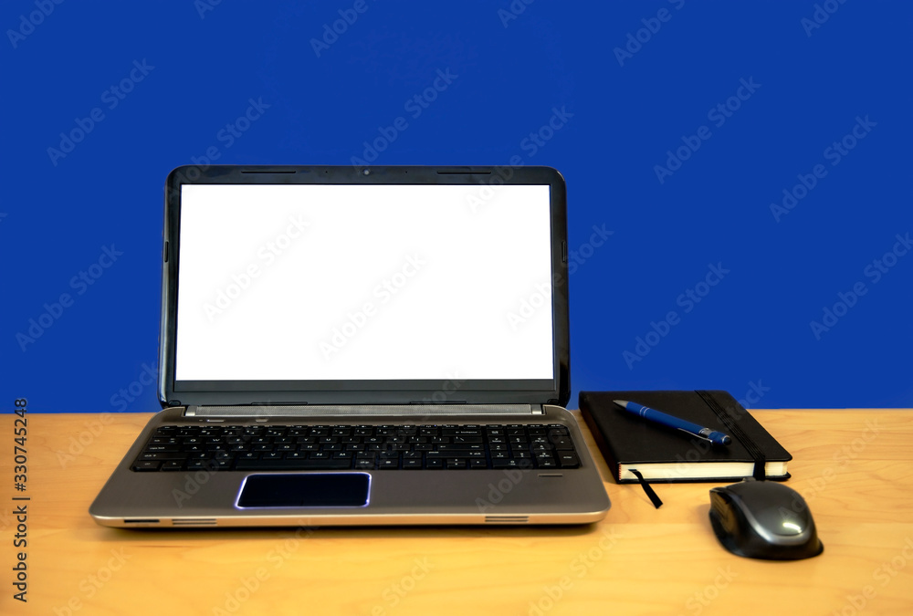 Workspace with Computer Laptop with Blank Screen on Phantom Blue Background Front View on Wooden Table and Copy space. Workspace with Computer Laptop with Blank Screen on Phantom Blue Background Front View on Wooden Table and Copy space.